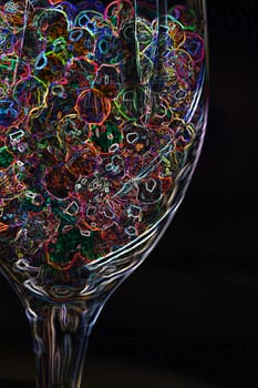 Abstract of Neon Beads in a glass.