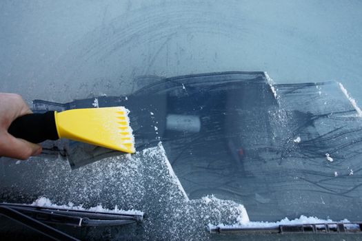 car windshield covered with ice and snow