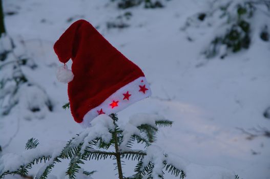 red santa claus hats in a snowy landscape