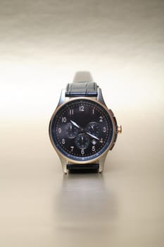 Modern wristwatch standing on nice silver background