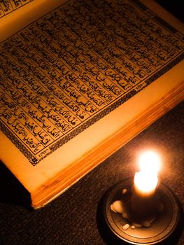 Al Qur'an and candle light.