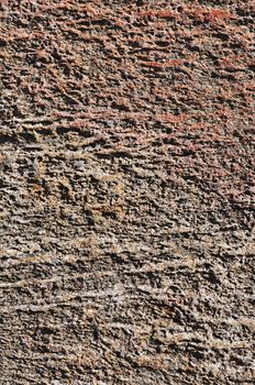 Fragment of natural rough brown stone surface