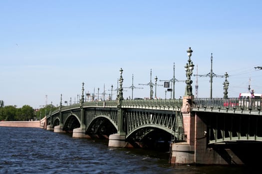 urban landscape: drawbridge, river, trees, big city
