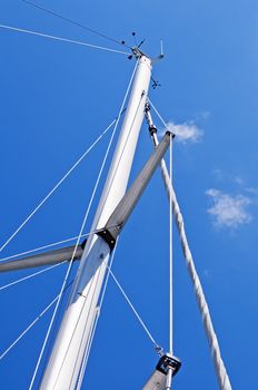 Mast of a sailboat against a blue sky