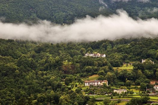 Isolated cloud on mountain with houses