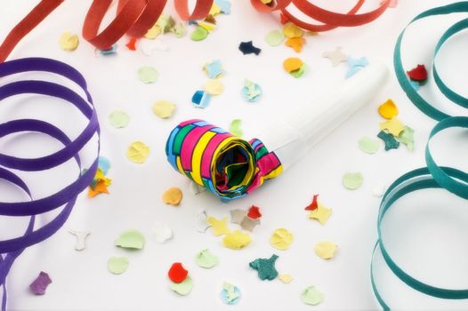 Party blower with confetti and streamers on white background