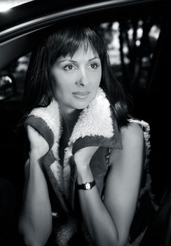 Portrait of a beautiful brunette in car