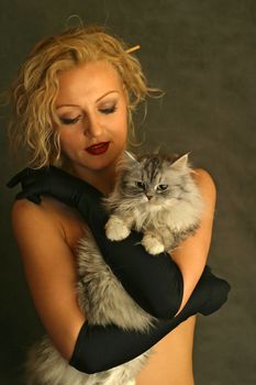 The beautiful girl embraces a kitten