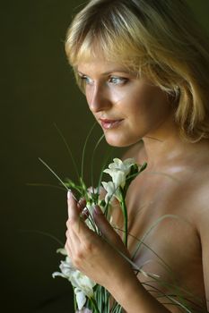 Portrait of the beautiful blonde with a bouquet of flowers