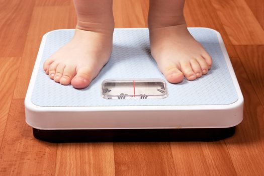 Closeup view of scales on a floor and kids feet