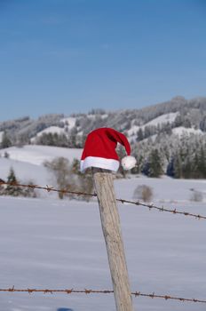 red santa claus hats in a snowy landscape