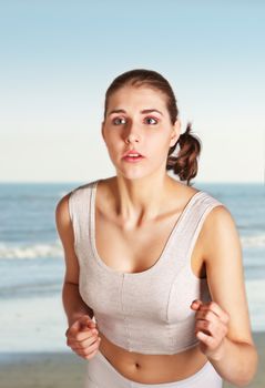 Pretty young woman jogging on the beach