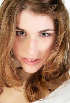 Closeup portrait of pretty young woman with long golden hair