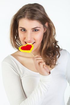 Portrait of smiling teenager girl holding colorful lollipop 