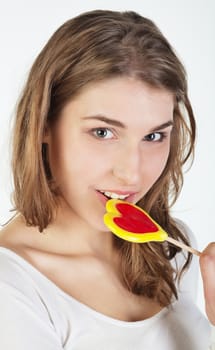 Portrait of smiling teenager girl holding colorful lollipop 