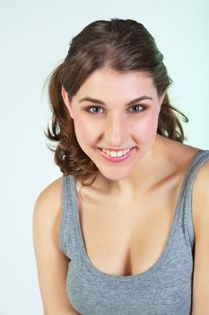 Portrait of smiling pretty teenager girl against white background