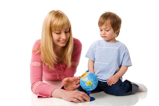 Happy mother holding globe with son isolated on white