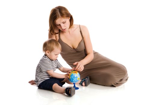 Happy mother holding globe with son isolated on white