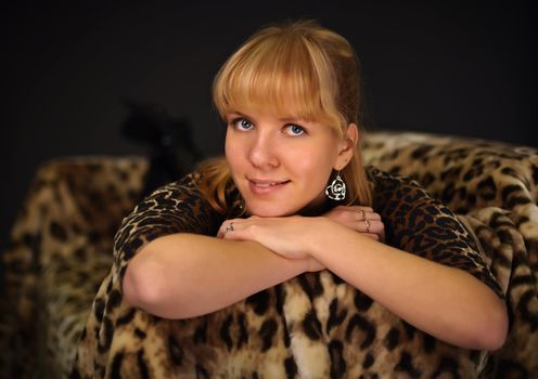 Portrait of a beautiful young girl in a leopard dress