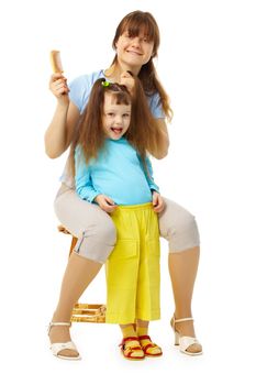 Cheerful mum and daughter do a hairdress on a white background