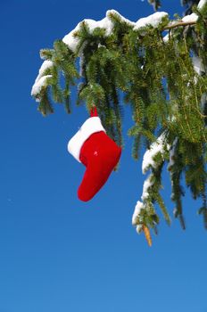 Santa Claus Christmas boot for gifts outside in a snowy landscape