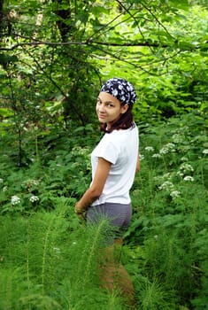 beautiful smiling teenage caucasian girl in park over natural green background outdoors