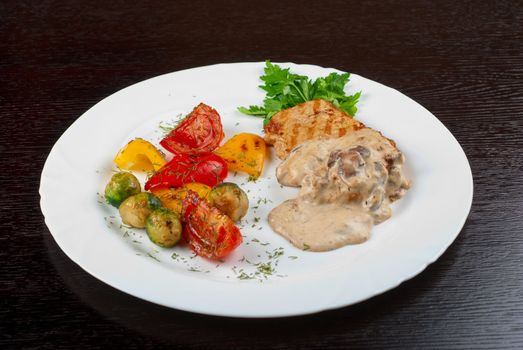 pork steak with mushroom sauce and grilled vegetables