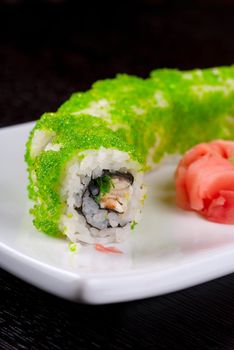 Sushi rolls made of salmon, avocado, flying fish roe - tobiko caviar and philadelphia cheese