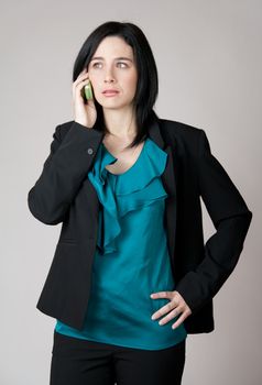 Business woman talking on the cell phone with worried expression.