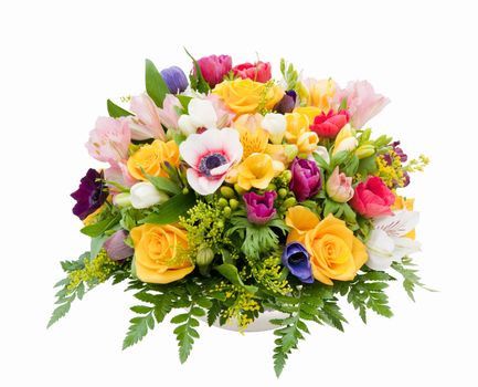 Professionally prepared decorative spring flower arrangement against white background