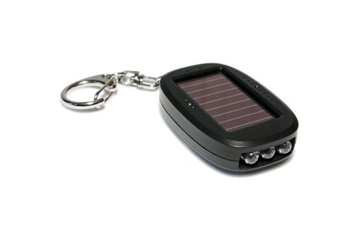Keychain Solar-powered flashlight. Close-up.