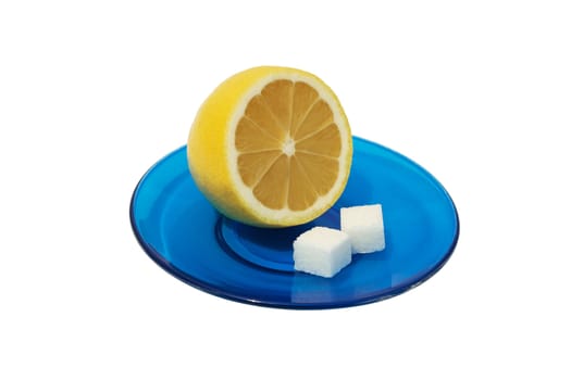 Lemon and two slices of sugar on a blue saucer. Isolated on white background.