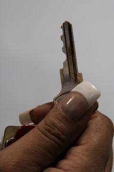 Close up of woman's hand holding a key.