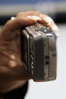 Close up of woman's hand holding digital camera.