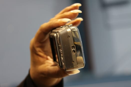 Close up of woman's hand holding digital camera.