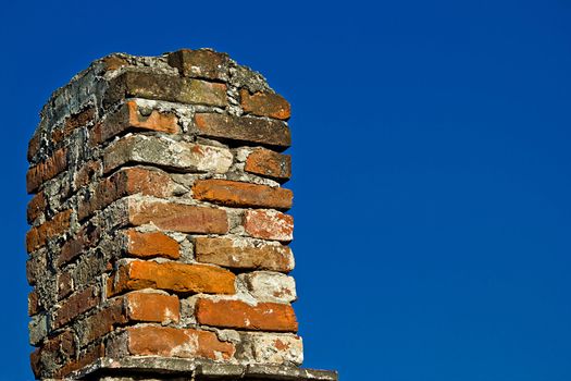 Old brick chimney and blue sky background