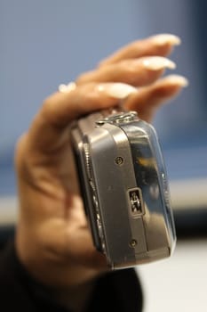 Close up of woman's hand holding digital camera.