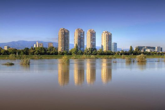 Residential buildings in croatian capital Zagreb, and reflections on river Sava when water level was high  