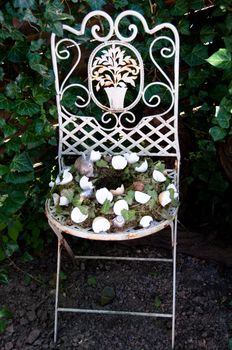 Easter Egg Wreath Decoration On Old Chair in Garden