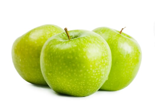 Three green apples over white background