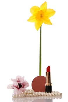 Pearls beads, cosmetics and flower on white background