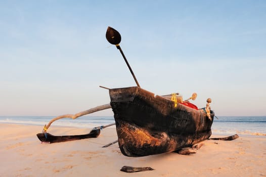 Wooden old fishing boat on the sandy shore