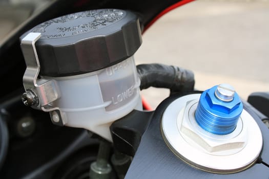 The brake oil level and the preload screw of a modern motorbike