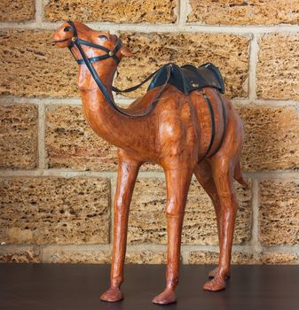 African figurine against the backdrop of a stone wall