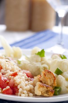 Couscous with tomatoes and fresh steamed  cauliflower and meat substitute.