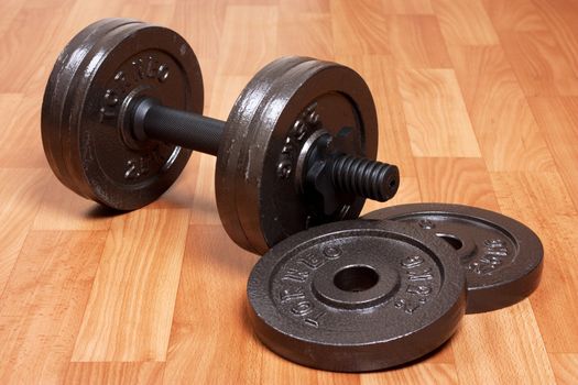 Single heavy dumbbell on a floor