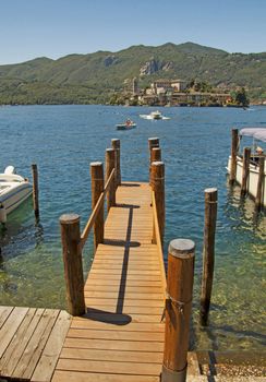 Long wooden pier getting into a lake