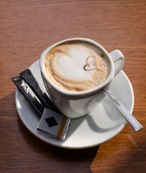 Cappuccino coffee cup closeup at the table