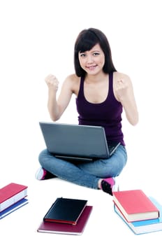 Successful young woman sitting on floor with laptop and books over white background.