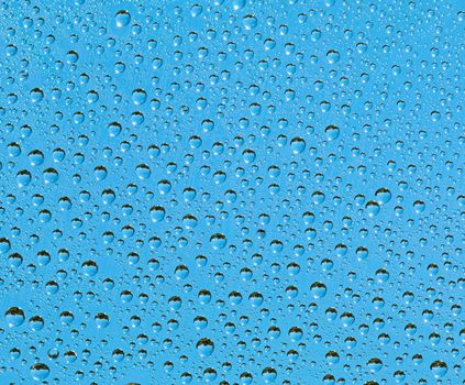 Natural background - a drop of rain on a transparent surface